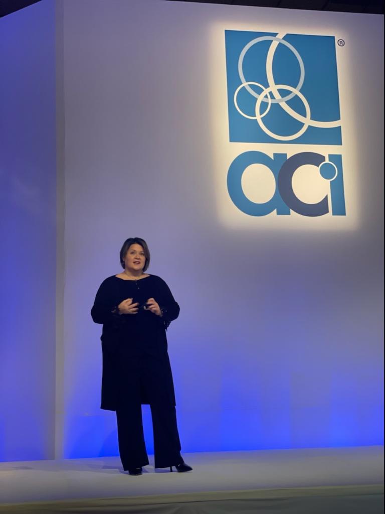 Amy Riccardi on stage at a keynote presentation